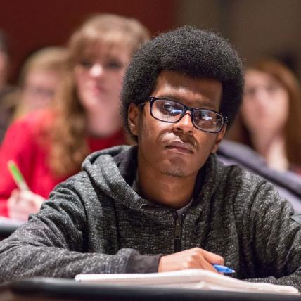 Serious-looking student in class