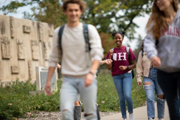 Hamline students walking on campus wearing Hamline gear