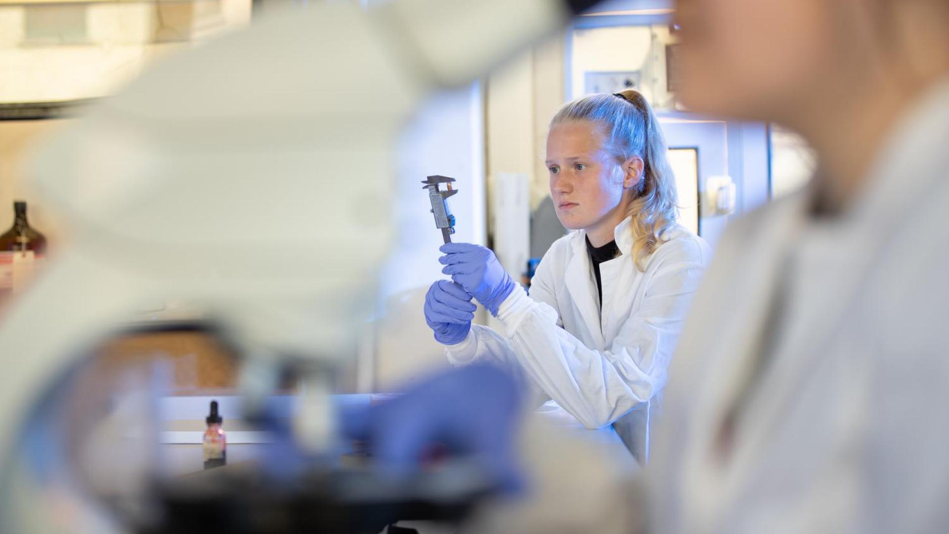 Student measuring evidence in Forensic Science program