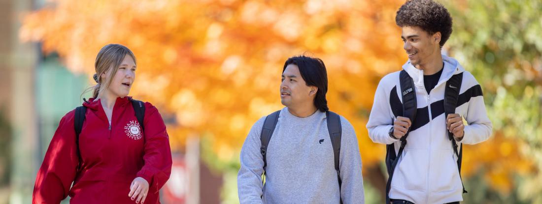 Students walking in fall foliage