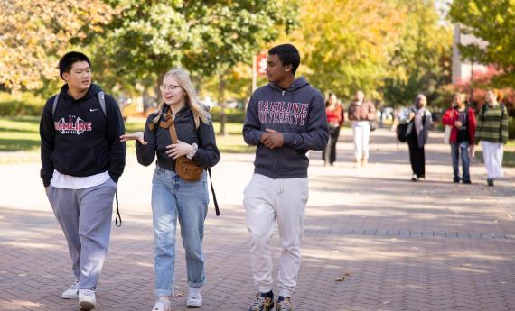 Three students walking on Hamline campus