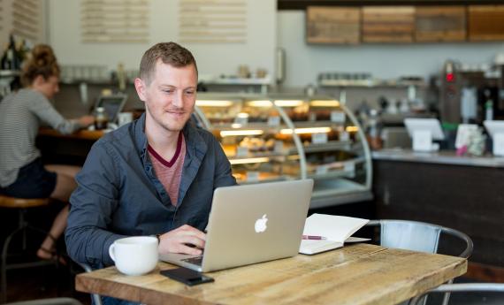 Online degree completion student at coffeeshop