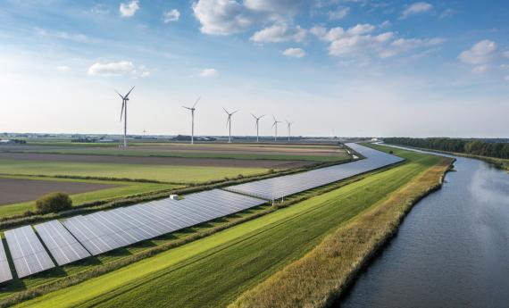 Wind turbines and solar panels illustrating alternative energy solutions (climate change stock)