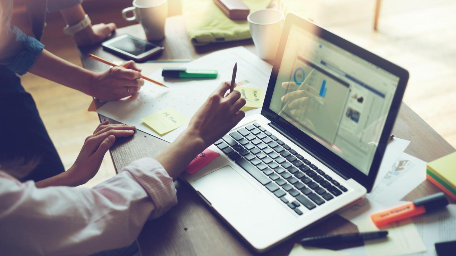 Business meeting, laptop with data graph (stock)